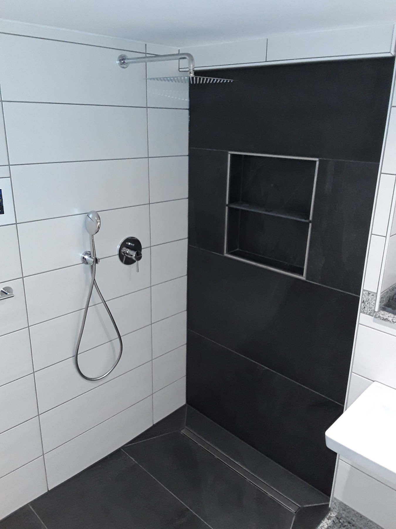 Dusche mit dunklen Natursteinplatten